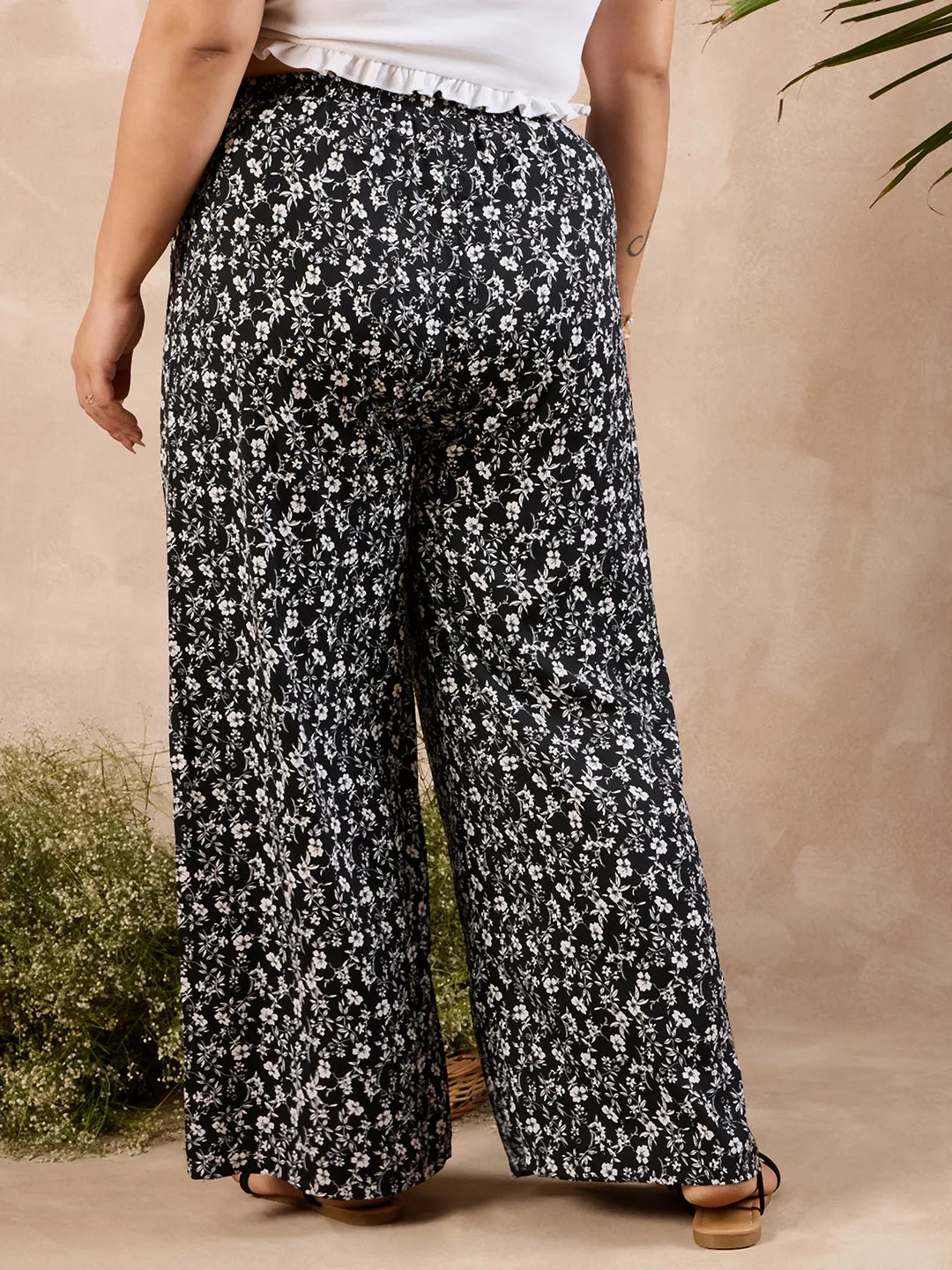 Berrylush Curve Women Black & White Floral Printed High-Rise Elastic Waist Relaxed-Fit Tie-Up Wide-Leg Trousers