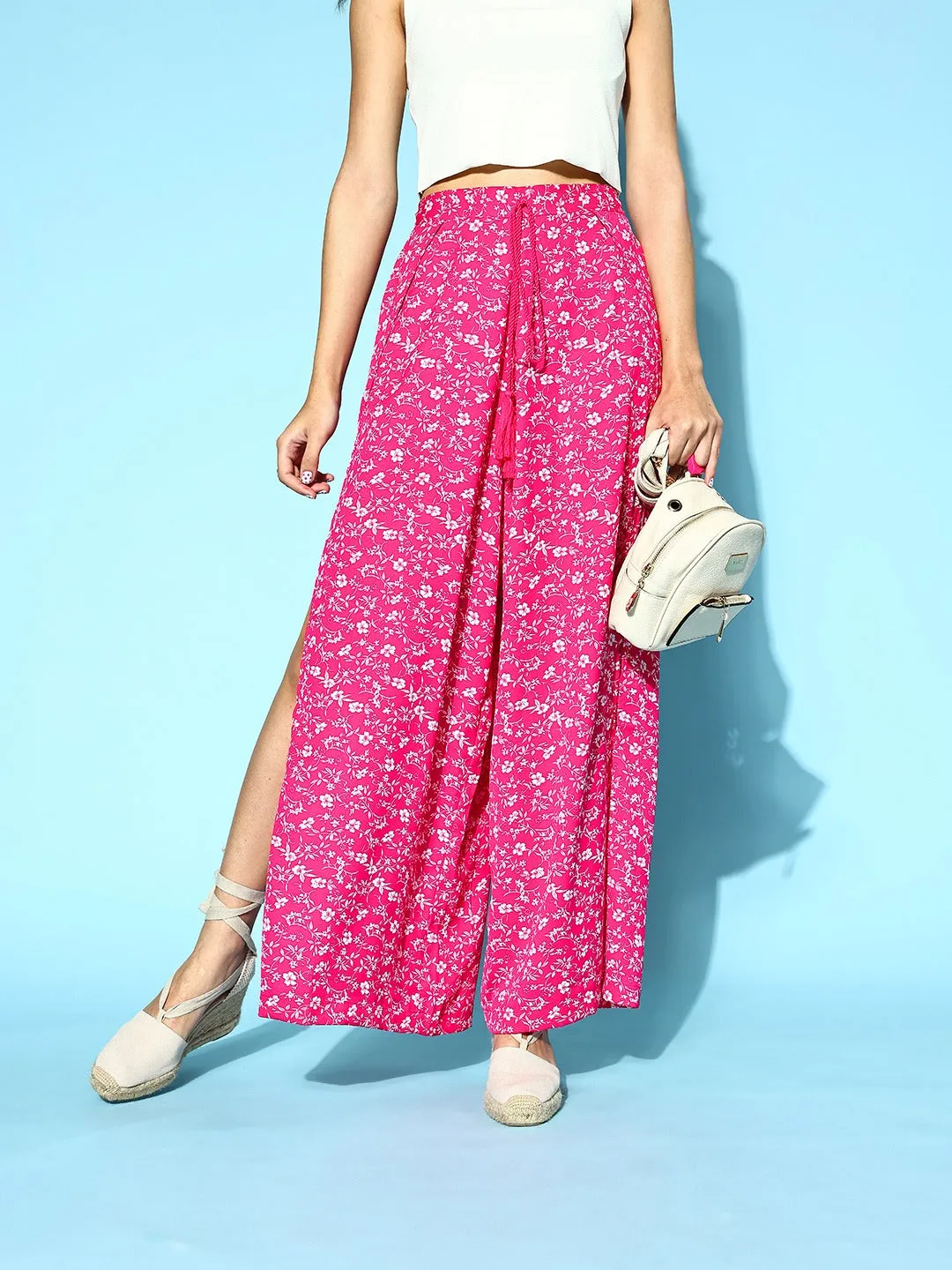 Berrylush Women Pink & White Floral Printed Mid-Rise Tie-Up Waist Side-Slit Tapered Regular Trousers